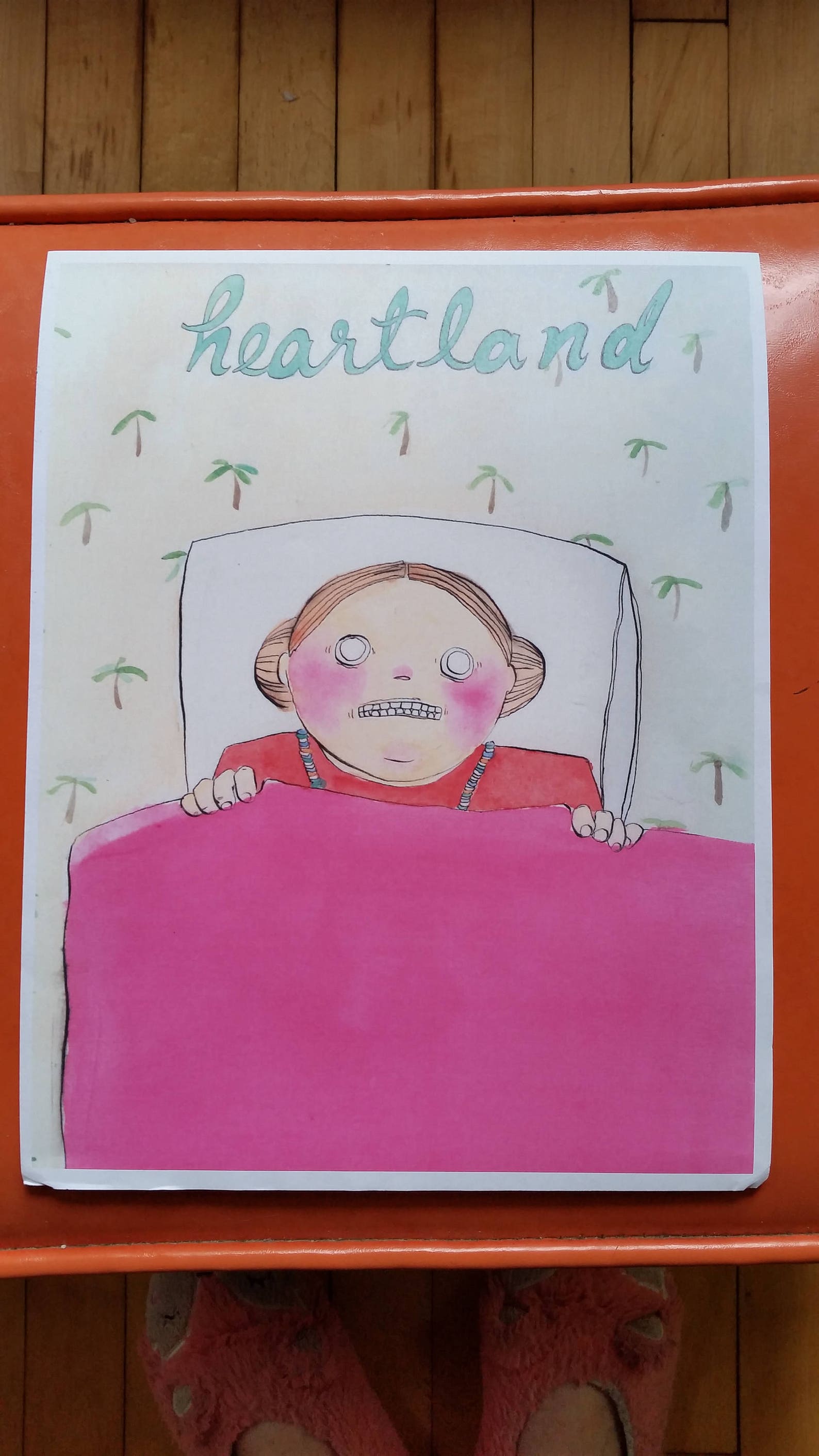 photo of zine: color comic of person in bed, blanket to their chin, question mark wallpaper