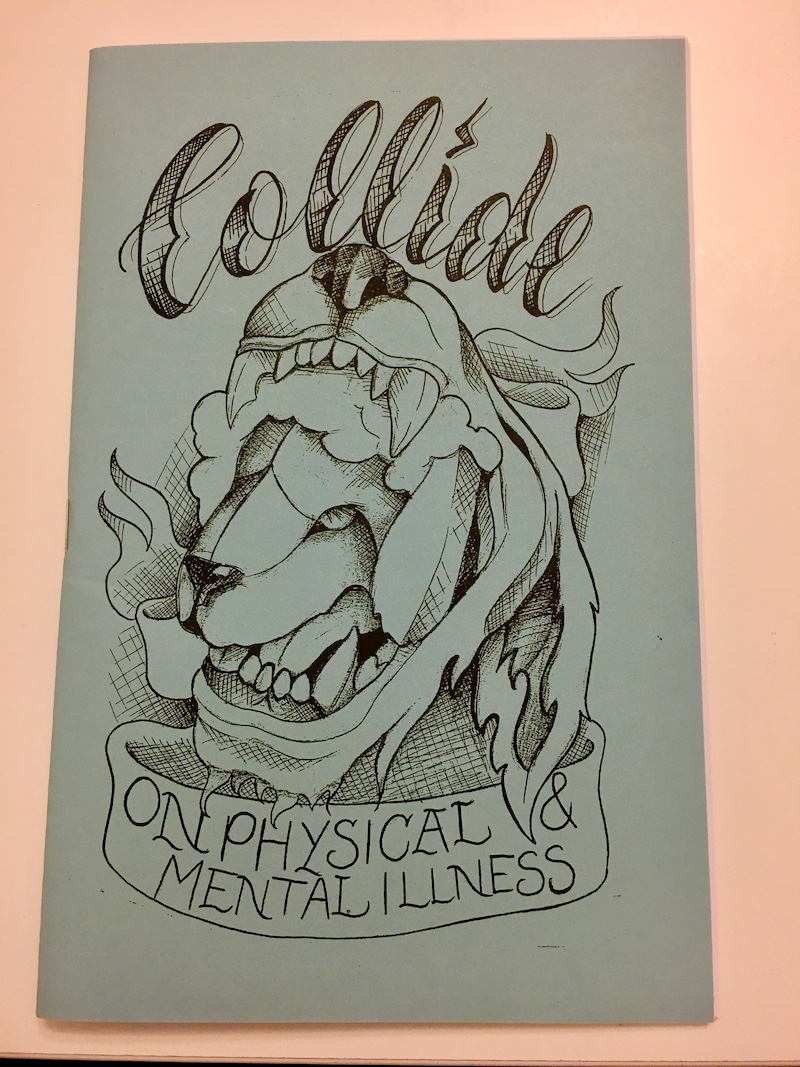 photo of a zine cover on a peach background. The zine has a tattoo slide title and a drawing of an animal with another animal in its open mouth